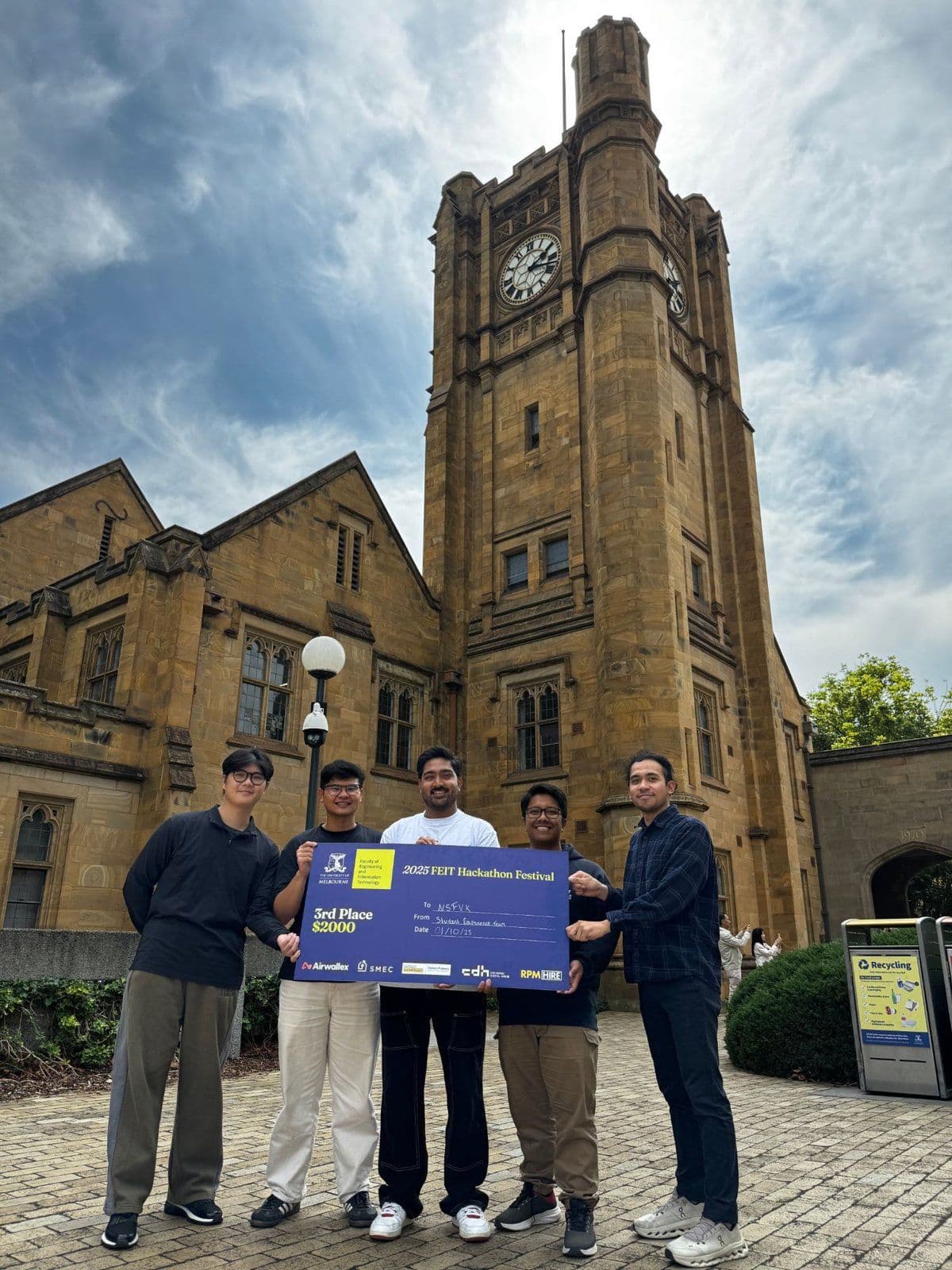 Kevin Bryan and four teammates holding a 2025 FEIT Hackathon Festival third place cheque at the University of Melbourne